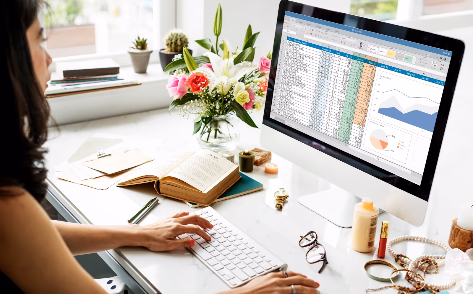 A woman using a computer, working on data entry